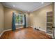 Bedroom featuring hardwood floors, a large window with curtains, and a closet at 230 Shag Bark Ln, Salisbury, NC 28146