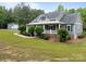 Home featuring a covered porch and a separate outbuilding on a spacious green lawn at 230 Shag Bark Ln, Salisbury, NC 28146