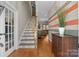 Inviting entryway with beautiful hardwood floors, stairs, and accent wall at 230 Shag Bark Ln, Salisbury, NC 28146