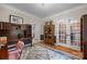 Bright home office featuring hardwood floors, wainscoting, and large multi-pane glass doors at 230 Shag Bark Ln, Salisbury, NC 28146