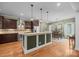 Spacious kitchen features a center island with stone countertop and stainless-steel appliances at 230 Shag Bark Ln, Salisbury, NC 28146
