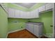 Laundry room features storage cabinets, folding counter, and plenty of space at 230 Shag Bark Ln, Salisbury, NC 28146