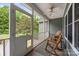 Relaxing screened porch with seating and ceiling fan, perfect for enjoying the outdoors at 230 Shag Bark Ln, Salisbury, NC 28146