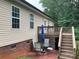 View of back patio with table, umbrella, chairs and stairs to the upper deck at 2339 Wednesbury Ct, Kannapolis, NC 28083