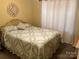 Cozy bedroom featuring a quilt covered bed and decorative wall art at 2339 Wednesbury Ct, Kannapolis, NC 28083