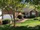 Charming brick home with a well-manicured lawn, flowerbeds, and a two-car garage at 2339 Wednesbury Ct, Kannapolis, NC 28083