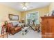 Living room with leather sofa, plants and natural light at 2339 Wednesbury Ct, Kannapolis, NC 28083