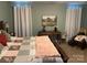 Main bedroom featuring a large bed with patterned bedding, soft lighting, and tasteful decorations at 2339 Wednesbury Ct, Kannapolis, NC 28083