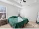 Bright bedroom featuring carpet floors, ample natural light, and a tray ceiling at 242 Delview Dr, Cherryville, NC 28021
