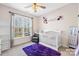 Bright Bedroom with a white crib, plush rug, a comfortable armchair, and charming decor at 242 Delview Dr, Cherryville, NC 28021