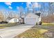 This home's exterior with the driveway leads to the garage and a small area with green grass at 242 Delview Dr, Cherryville, NC 28021