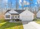 Charming single-Gathering home with white siding, a front-facing garage, and a well-manicured lawn at 242 Delview Dr, Cherryville, NC 28021