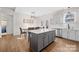 Spacious kitchen with wood floors, gray island, stainless appliances, and a breakfast nook at 242 Delview Dr, Cherryville, NC 28021