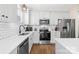Modern kitchen features stainless steel appliances, white subway tile backsplash, and sleek countertops at 242 Delview Dr, Cherryville, NC 28021