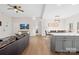 Open-concept living room with a kitchen island, hardwood floors, and backyard access at 242 Delview Dr, Cherryville, NC 28021
