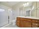 Bathroom with a large vanity, shower, and mirror, offering a clean and functional space at 28129 Song Sparrow Ln, Fort Mill, SC 29707