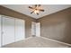 Bedroom with carpet, double closets, a ceiling fan, and white doors and trim at 28129 Song Sparrow Ln, Fort Mill, SC 29707