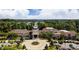 Exterior view of the grand community clubhouse surrounded by lush landscaping and a circular driveway at 28129 Song Sparrow Ln, Fort Mill, SC 29707