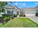 Charming single-story home featuring manicured landscaping and an attached two-car garage at 28129 Song Sparrow Ln, Fort Mill, SC 29707