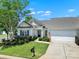 Inviting one-story home with neat landscaping, a well-kept lawn, a driveway, and an attached two-car garage at 28129 Song Sparrow Ln, Fort Mill, SC 29707