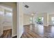 Bright living room showcasing wood floors, a ceiling fan, and a sliding glass door leading to an outdoor space at 28129 Song Sparrow Ln, Fort Mill, SC 29707