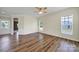 Bright living room with wood floors and multiple windows, creating a welcoming atmosphere at 28129 Song Sparrow Ln, Fort Mill, SC 29707