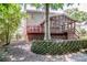 A spacious backyard featuring a screened-in porch, wooden deck, and brick retaining wall at 292 Rose St, Mooresville, NC 28117