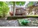 View of back of house featuring screened porch, wooden deck, brick terracing, and mature trees at 292 Rose St, Mooresville, NC 28117