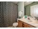 This cozy bathroom offers a sink with a marble countertop and a black and white patterned shower curtain at 292 Rose St, Mooresville, NC 28117