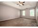A spacious bedroom featuring neutral walls and carpeting, complemented by windows providing natural light at 292 Rose St, Mooresville, NC 28117