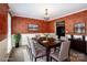 Dining room features dark wood table, gray upholstered chairs, chandelier, decorative wallpaper and neutral carpet at 292 Rose St, Mooresville, NC 28117