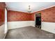 A dining room featuring elegant wallpaper, chandelier, and neutral carpeting for a comfortable ambiance at 292 Rose St, Mooresville, NC 28117