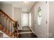 Inviting foyer featuring tile flooring, stairs, and a decorative front door with glass detail at 292 Rose St, Mooresville, NC 28117
