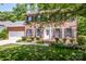 Charming brick home with lush front yard landscaping, black shutters, and a welcoming front porch at 292 Rose St, Mooresville, NC 28117