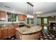Kitchen with stainless steel appliances, granite counters, wood cabinets, pendant lighting and kitchen island at 292 Rose St, Mooresville, NC 28117