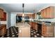 Kitchen with stainless steel appliances, granite counters, wood cabinets, pendant lighting and checkerboard flooring at 292 Rose St, Mooresville, NC 28117