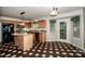 Kitchen with stainless steel appliances, granite counters, wood cabinets, pendant lighting and checkerboard flooring at 292 Rose St, Mooresville, NC 28117