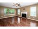 Bright living room featuring hardwood floors, a fireplace, and ample natural light from large windows at 292 Rose St, Mooresville, NC 28117