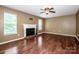 Bright living room featuring hardwood floors, a fireplace, and ample natural light from large windows at 292 Rose St, Mooresville, NC 28117