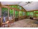 This cozy screened-in porch offers wooden floors, lots of light, and two chairs at 292 Rose St, Mooresville, NC 28117
