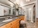 Luxurious bathroom with double vanity, stone floors, and modern lighting fixtures at 3044 Luke Crossing Dr, Charlotte, NC 28226