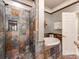 Elegant bathroom featuring a luxurious jacuzzi tub and a separate shower with unique stone tile surround at 3044 Luke Crossing Dr, Charlotte, NC 28226