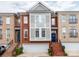 Charming townhome with brick facade, attached garage, and a welcoming blue front door at 3044 Luke Crossing Dr, Charlotte, NC 28226