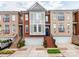 Attractive brick townhome with a well-manicured lawn and attached garages at 3044 Luke Crossing Dr, Charlotte, NC 28226