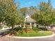 Charming gazebo on a well-maintained landscaped island surrounded by trees and plants at 3044 Luke Crossing Dr, Charlotte, NC 28226