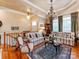 Inviting living room features hardwood floors, a chandelier, and ample natural light at 3044 Luke Crossing Dr, Charlotte, NC 28226
