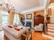 Elegant living room featuring a fireplace, hardwood floors, and a decorative chandelier at 3044 Luke Crossing Dr, Charlotte, NC 28226