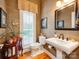 Elegant powder room with decorative wallpaper, wood floors and natural light at 3044 Luke Crossing Dr, Charlotte, NC 28226