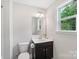 Well-lit bathroom with a dark vanity, white walls, and modern fixtures at 3218 Gilroy Dr, Fort Mill, SC 29707