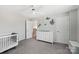 Bedroom with modern white crib, dresser, ceiling fan, and cute sea-themed wall decals at 3218 Gilroy Dr, Fort Mill, SC 29707